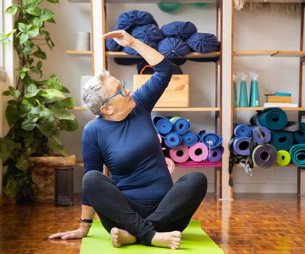 A person stretching peacefully, symbolizing increased energy and mental clarity.